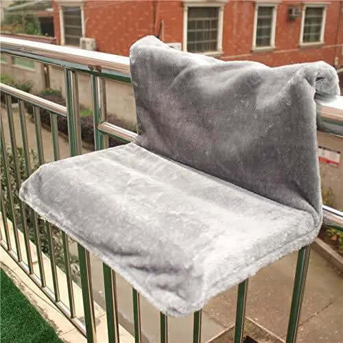 Cat bed cat hammock mounted on a balcony railing, soft plush material for feline relaxation.
